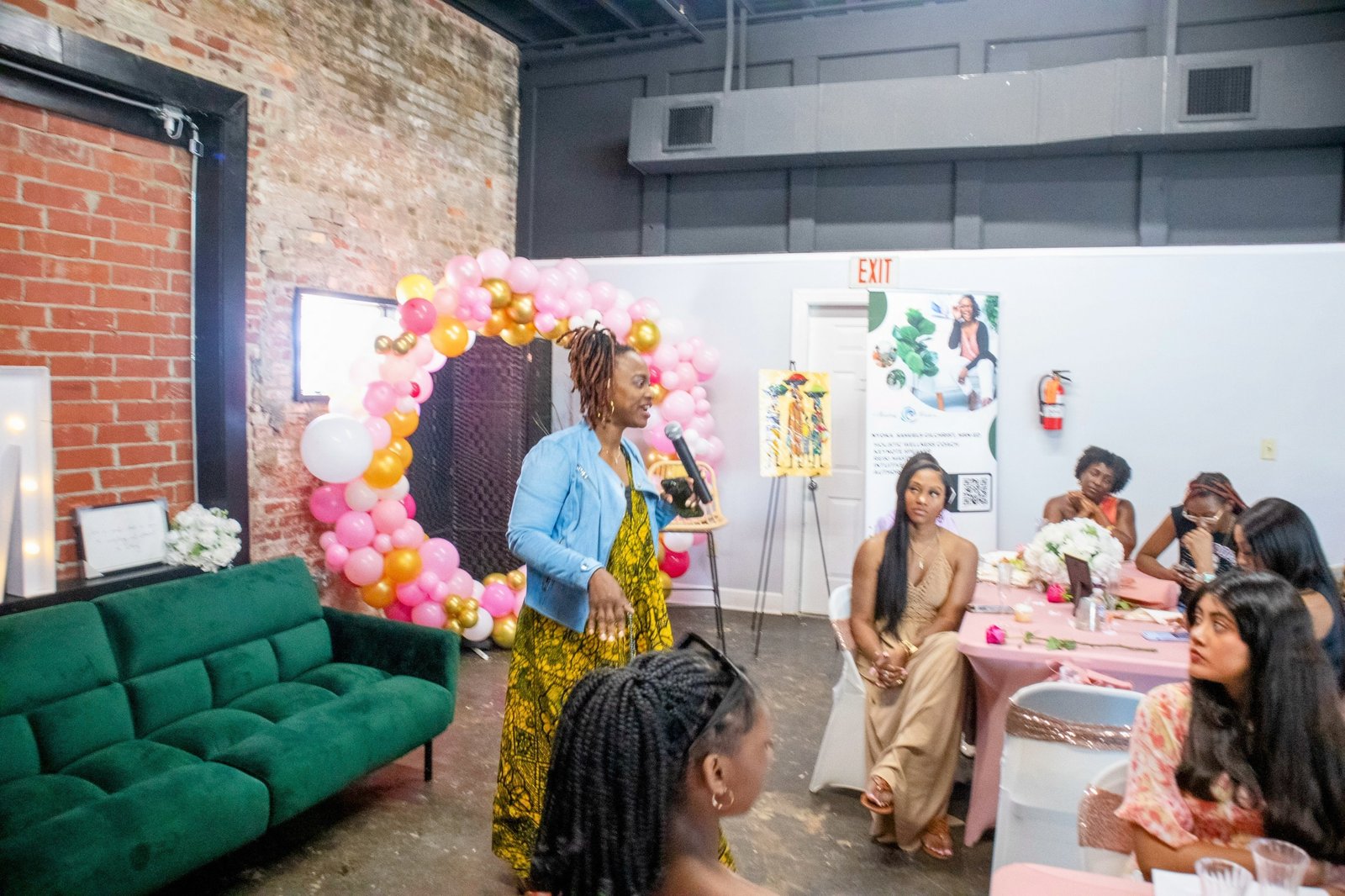 Nyoka leading a live coaching event with attendees in a warm, intimate setting
